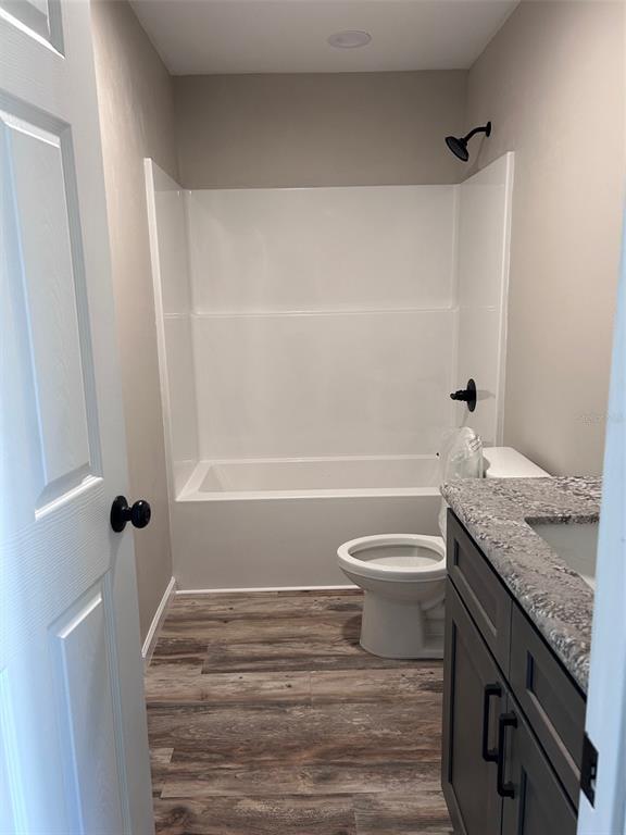 570 Southwest 5th Street Lake Butler, FL 32054 - Photo 5 of 11 a bathroom with a granite countertop sink toilet and shower