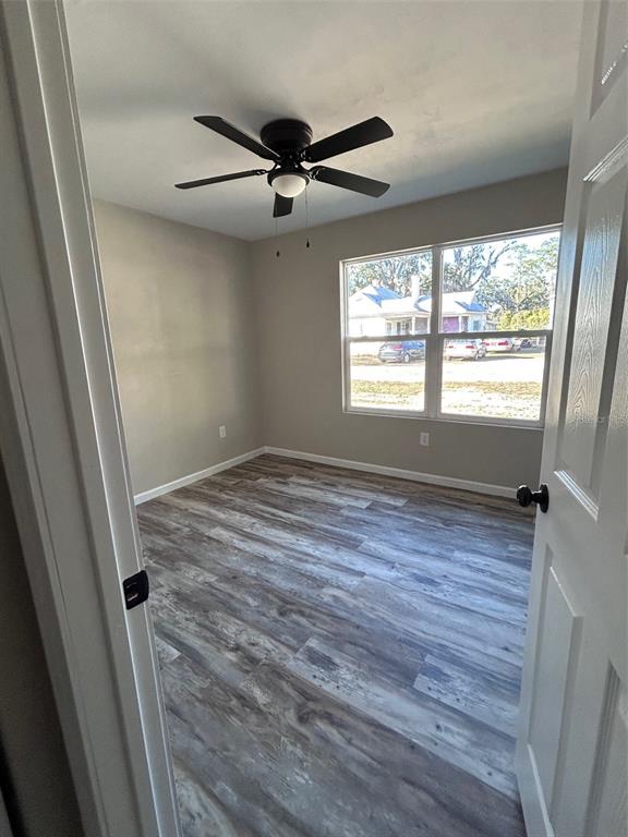 570 Southwest 5th Street Lake Butler, FL 32054 - Photo 8 of 11 a view of an empty room with wooden floor and a window