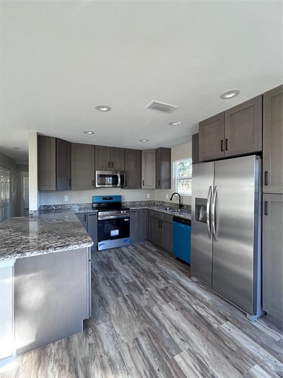 570 Southwest 5th Street Lake Butler, FL 32054 - Photo 10 of 11 a kitchen with stainless steel appliances granite countertop a refrigerator a sink a stove and oven