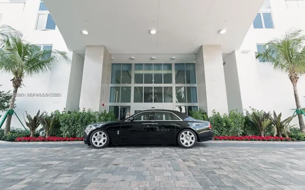 a living room with fireplace furniture and a large window