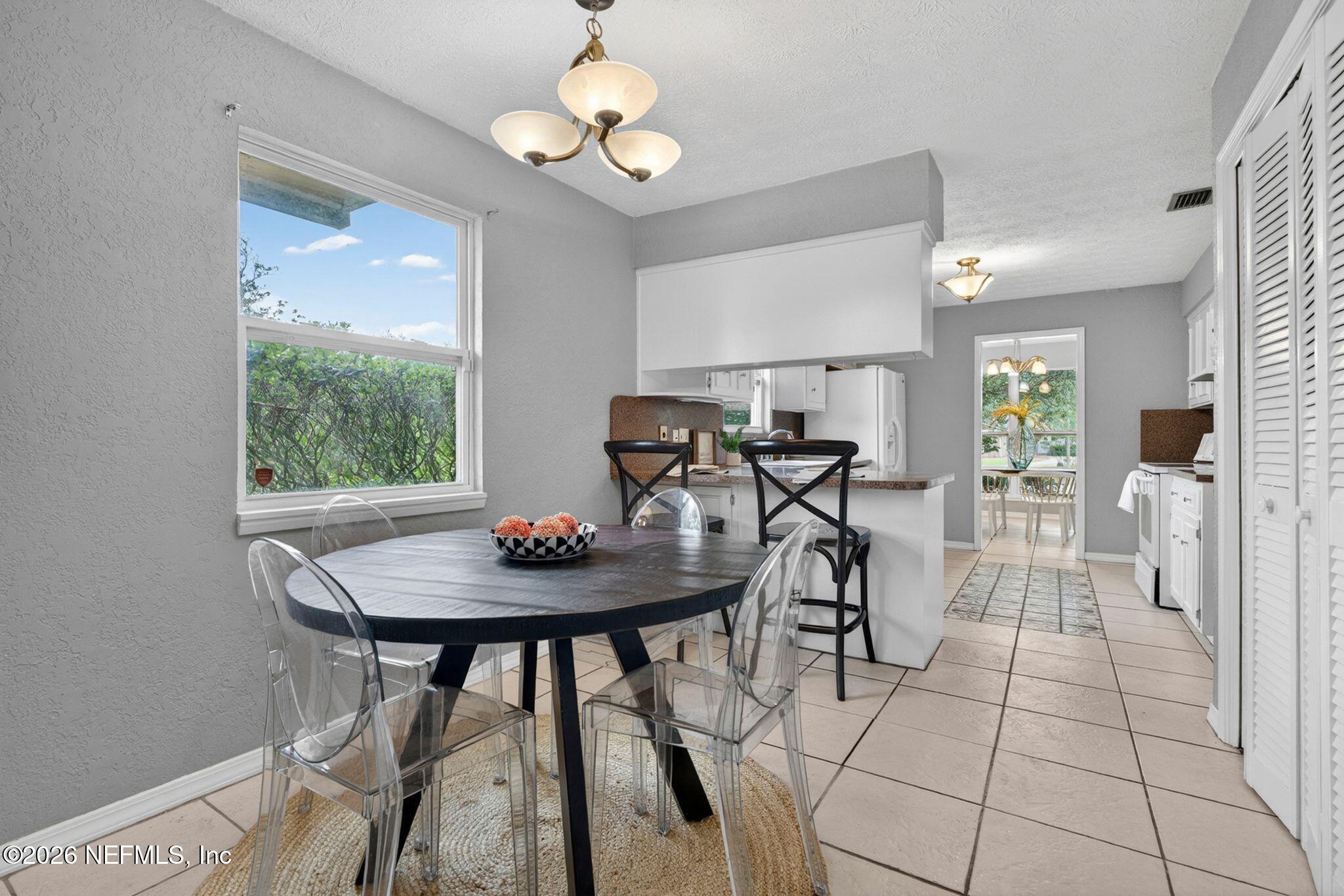 138 Ridgefield Court Orange Park, FL 32065 - Photo 23 of 64 a view of a dining room with furniture and wooden floor