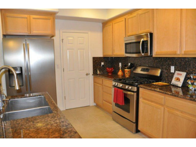 1797 Snell Place Milpitas, CA 95035 - Photo 11 of 25 a kitchen with stainless steel appliances granite countertop a sink stove and microwave