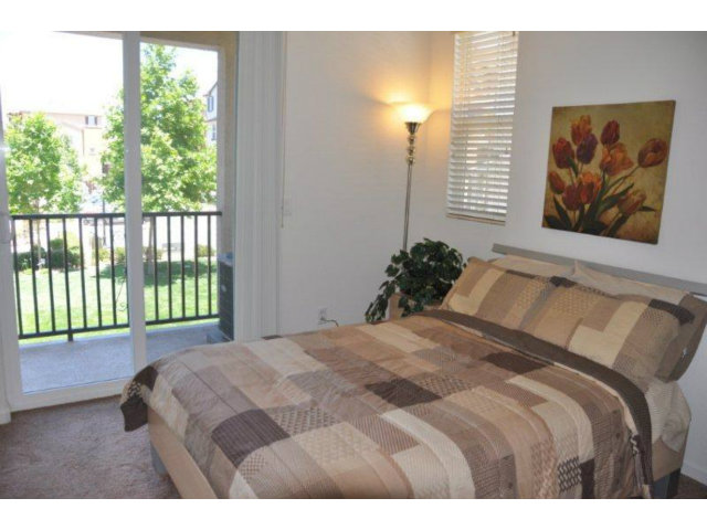 1797 Snell Place Milpitas, CA 95035 - Photo 20 of 25 a bedroom with a bed and a window
