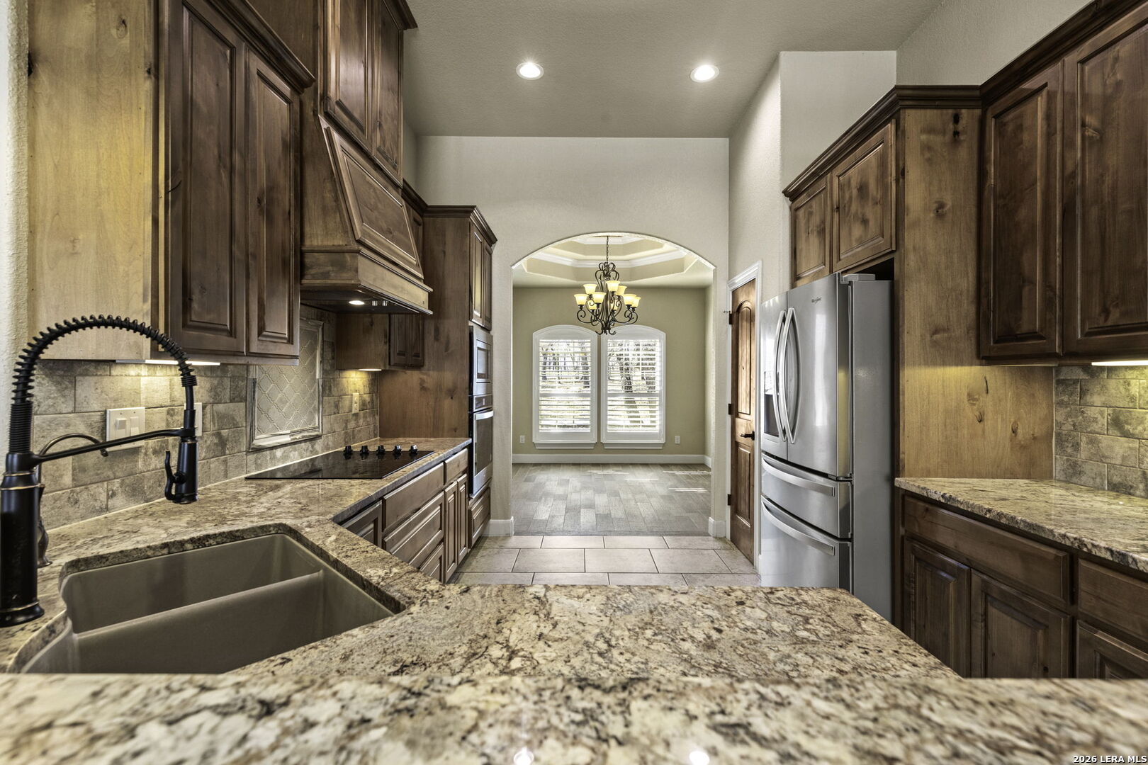 520 Arbor View Adkins, TX 78101 - Photo 14 of 32 a kitchen with granite countertop a refrigerator and a sink