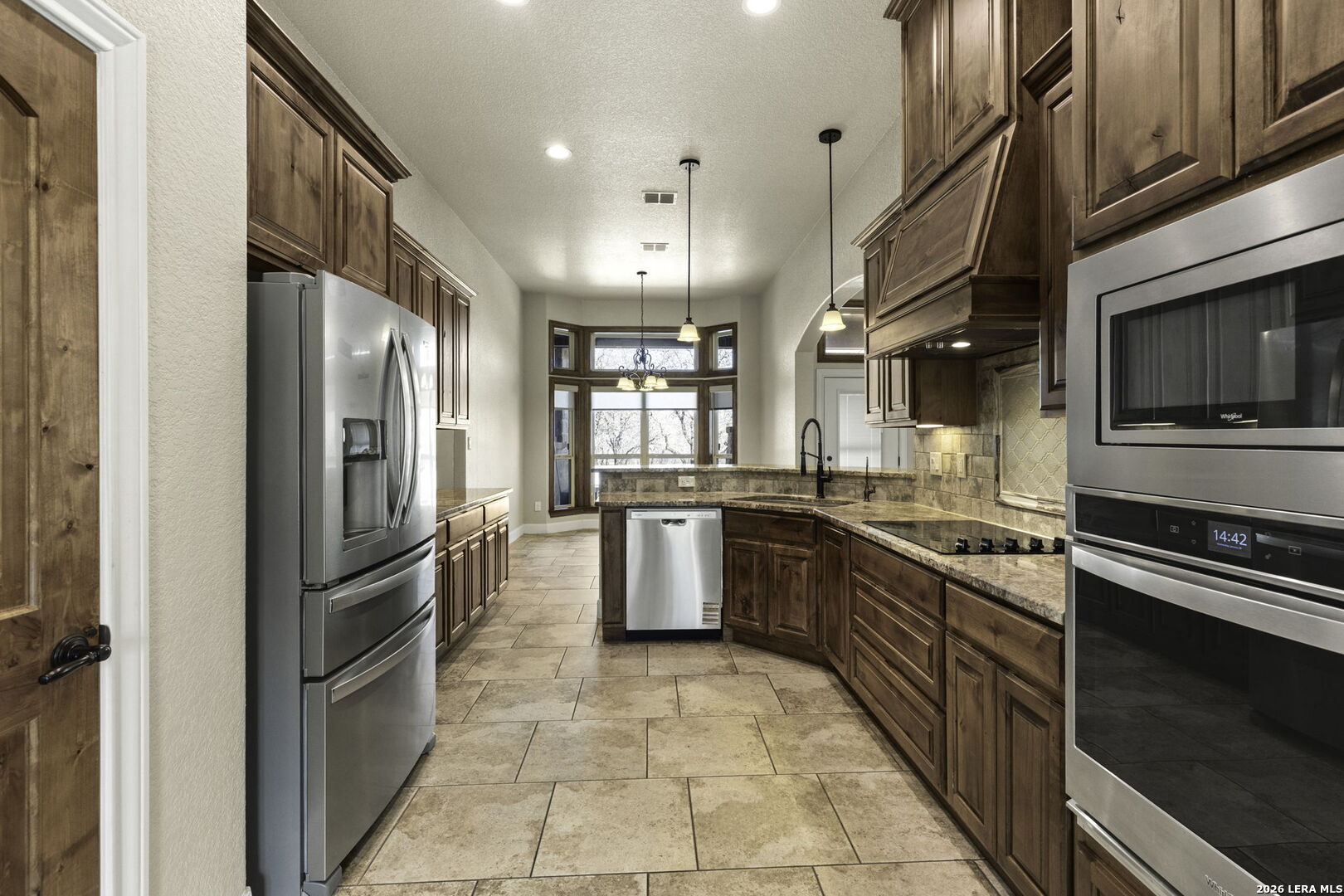 520 Arbor View Adkins, TX 78101 - Photo 16 of 32 a kitchen with stainless steel appliances granite countertop a refrigerator a stove and a sink