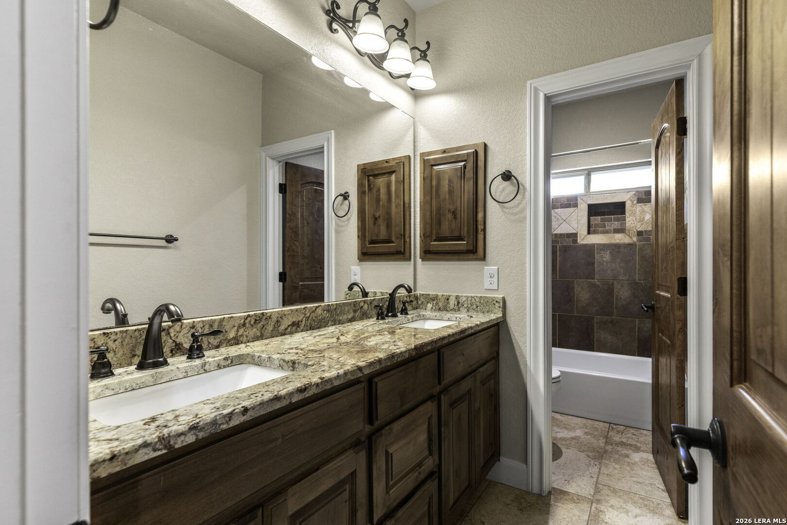 520 Arbor View Adkins, TX 78101 - Photo 24 of 32 a bathroom with a granite countertop sink a mirror and a shower