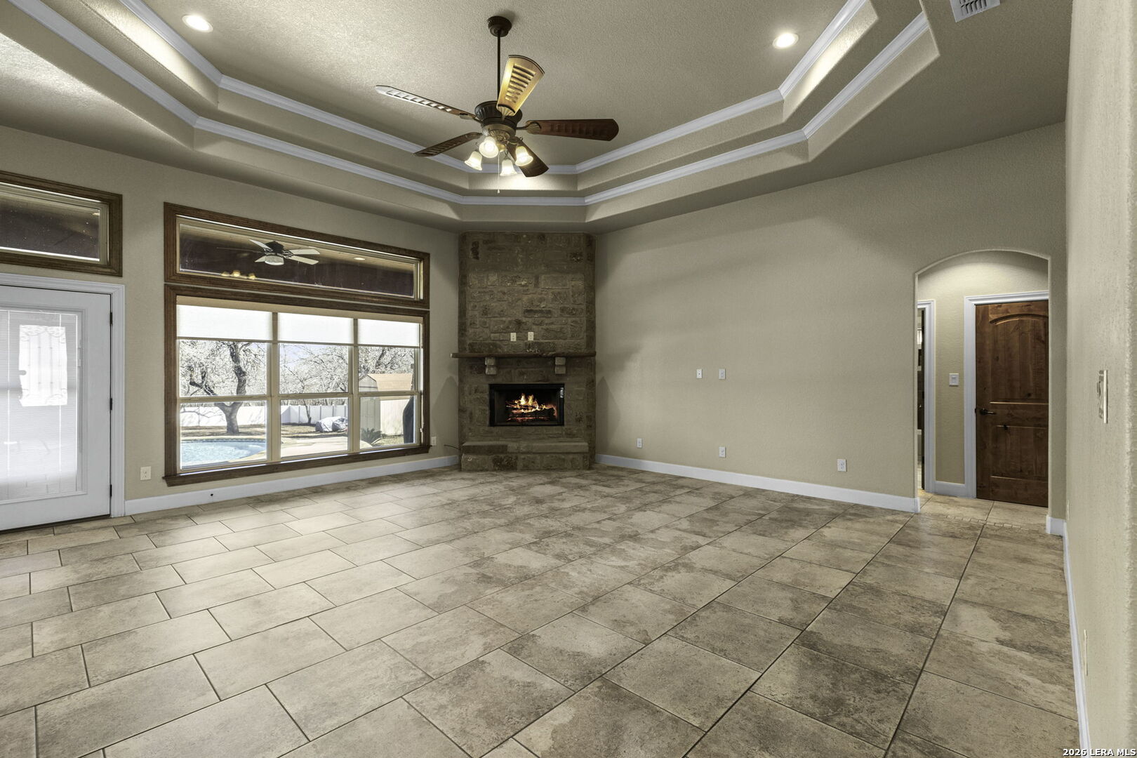 520 Arbor View Adkins, TX 78101 - Photo 9 of 32 a view of an empty room with a fireplace and a chandelier