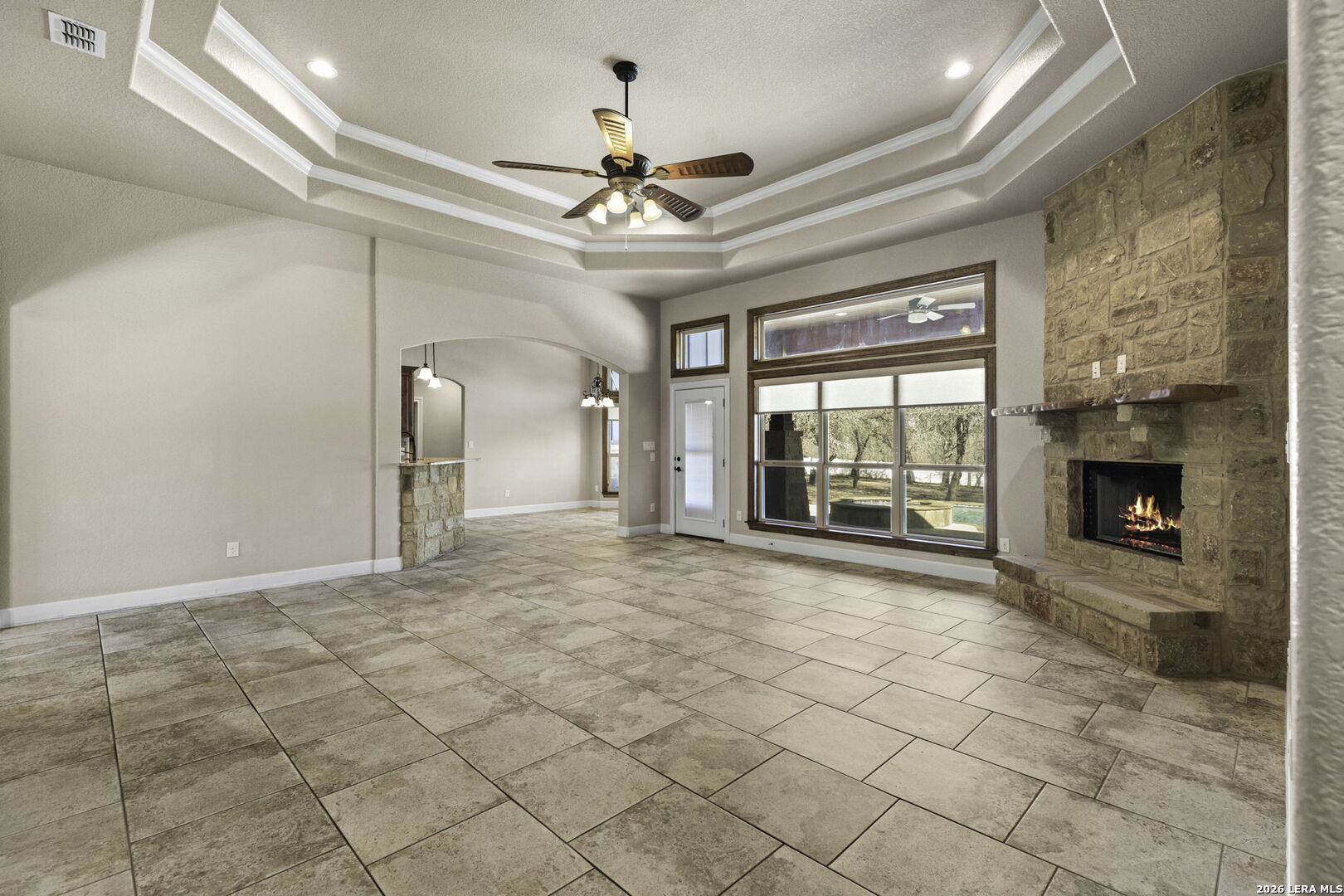 520 Arbor View Adkins, TX 78101 - Photo 10 of 32 a view of an empty room with a fireplace and a chandelier