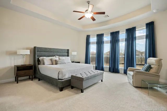 a spacious bedroom with a bed and a couch