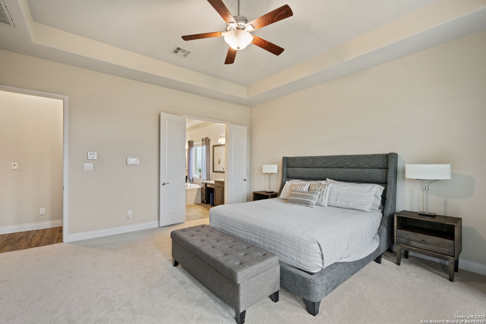 7938 Cibolo Boerne, TX 78015 - Photo 22 of 37 a bedroom with a bed and a chandelier