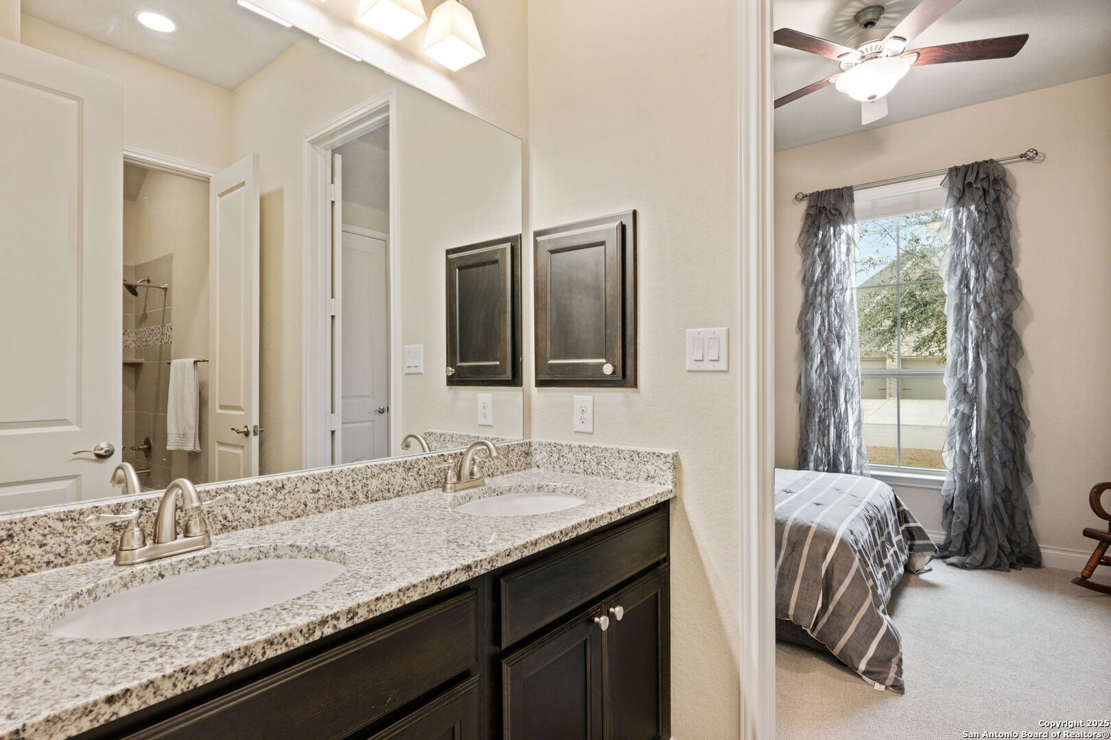 7938 Cibolo Boerne, TX 78015 - Photo 26 of 37 a en suite bathroom with a granite countertop sink and a mirror