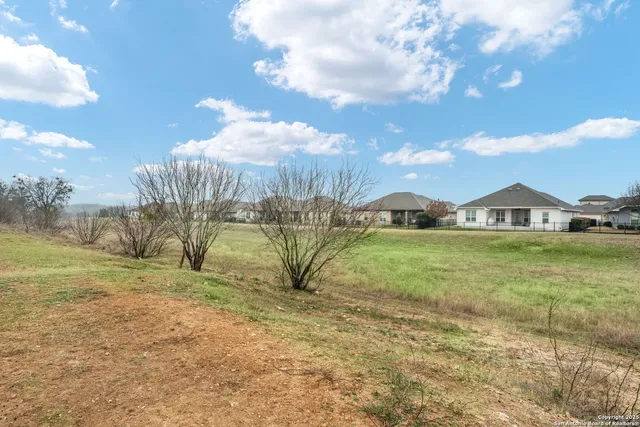 a view of lawn chairs and iron fence