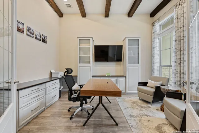 a living room with furniture a rug and a flat screen tv