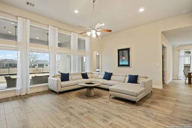 a living room with furniture and a large window