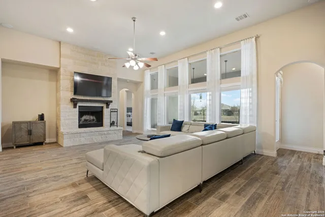 a living room with fireplace furniture and a flat screen tv