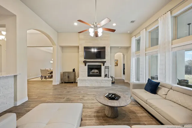 a living room with furniture a fireplace and a flat screen tv