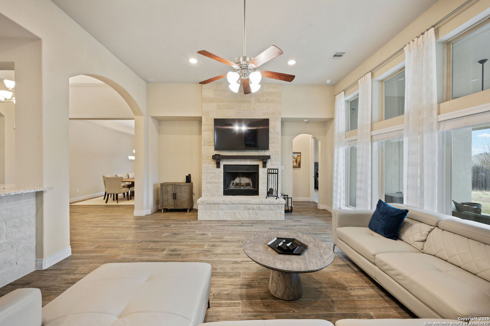 7938 Cibolo Boerne, TX 78015 - Photo 10 of 37 a living room with furniture a fireplace and a flat screen tv