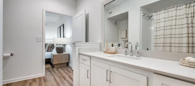 a en suite bathroom with double sink and a mirror