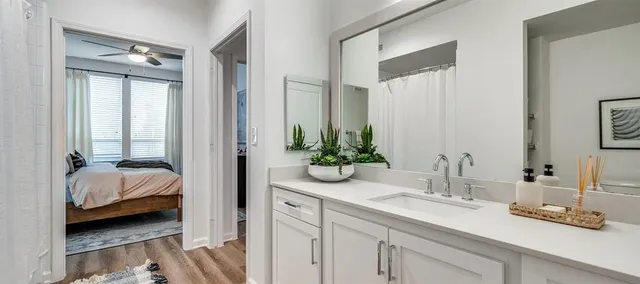 a en suite bathroom with double sink and a mirror