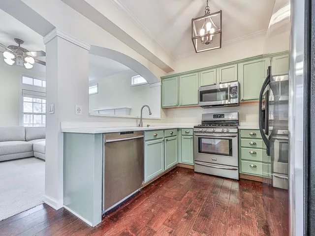 a kitchen with stainless steel appliances a stove and a refrigerator