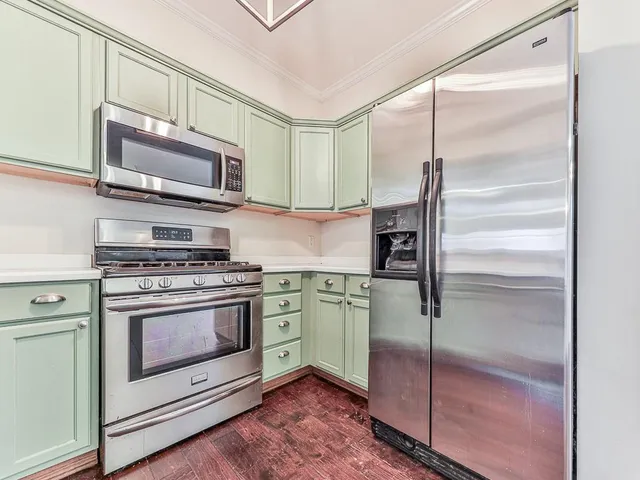 a kitchen with a refrigerator stove and microwave