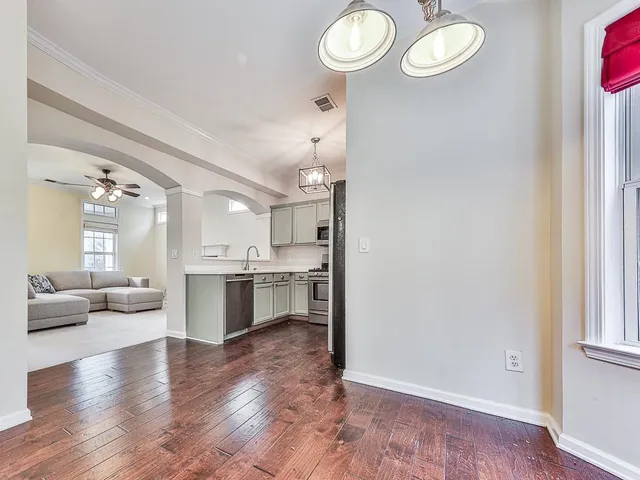 a view of a kitchen and dining room with wooden floor