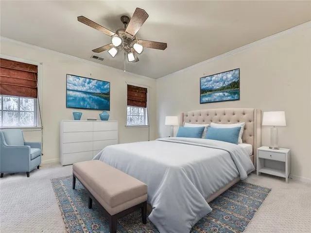 an empty room with a chandelier fan and windows