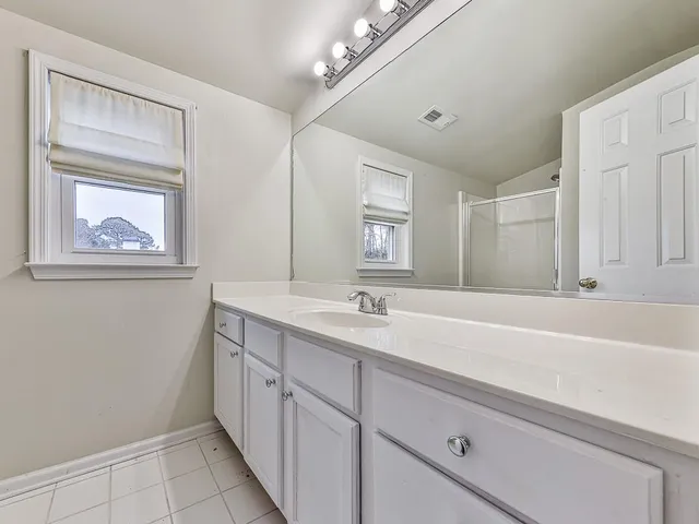 a bathroom with a glass shower door