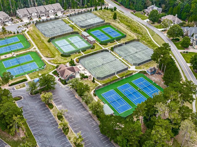 an aerial view of a house with a garden and lake view