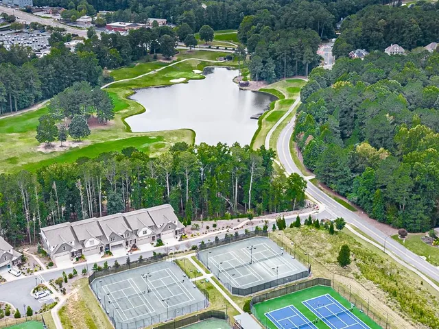 an aerial view of a swimming pool with outdoor seating
