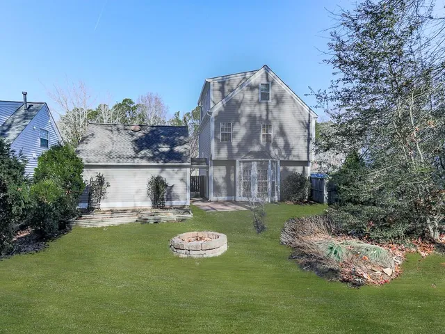 a view of a house with backyard and sitting area