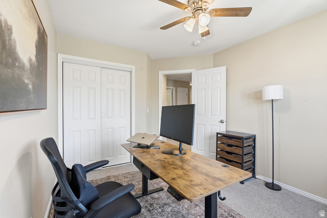 99 Penhurst Place Logan, UT 84341 - Photo 22 of 34 Neutral-toned room featuring a ceiling fan with integrated lighting, paneled doors, and carpeted flooring
