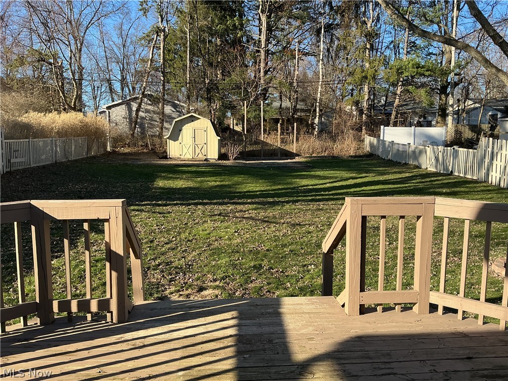 1850 Merle Road Salem, OH 44460 - Photo 32 of 35 Fenced backyard with a deck and a storage unit