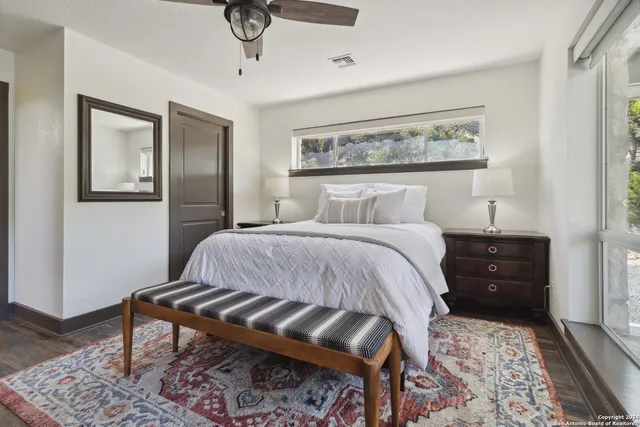 a large white kitchen with a large window