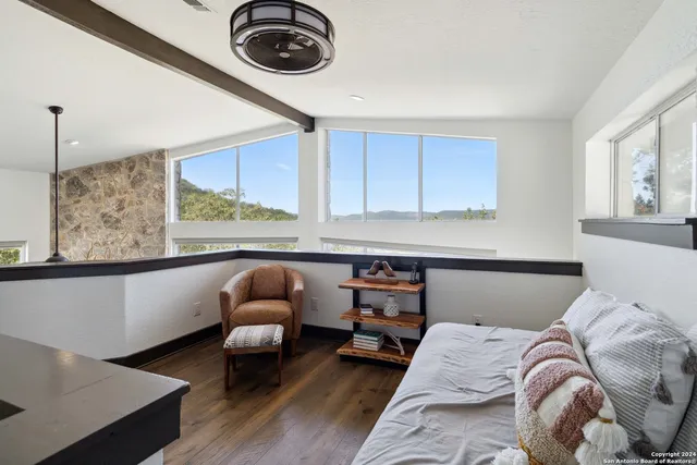 a bedroom with a bed and a chair