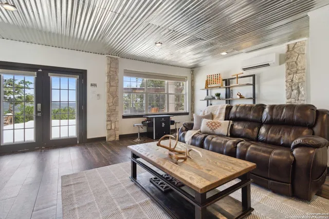 a front view of a house with a yard and mountain view in back