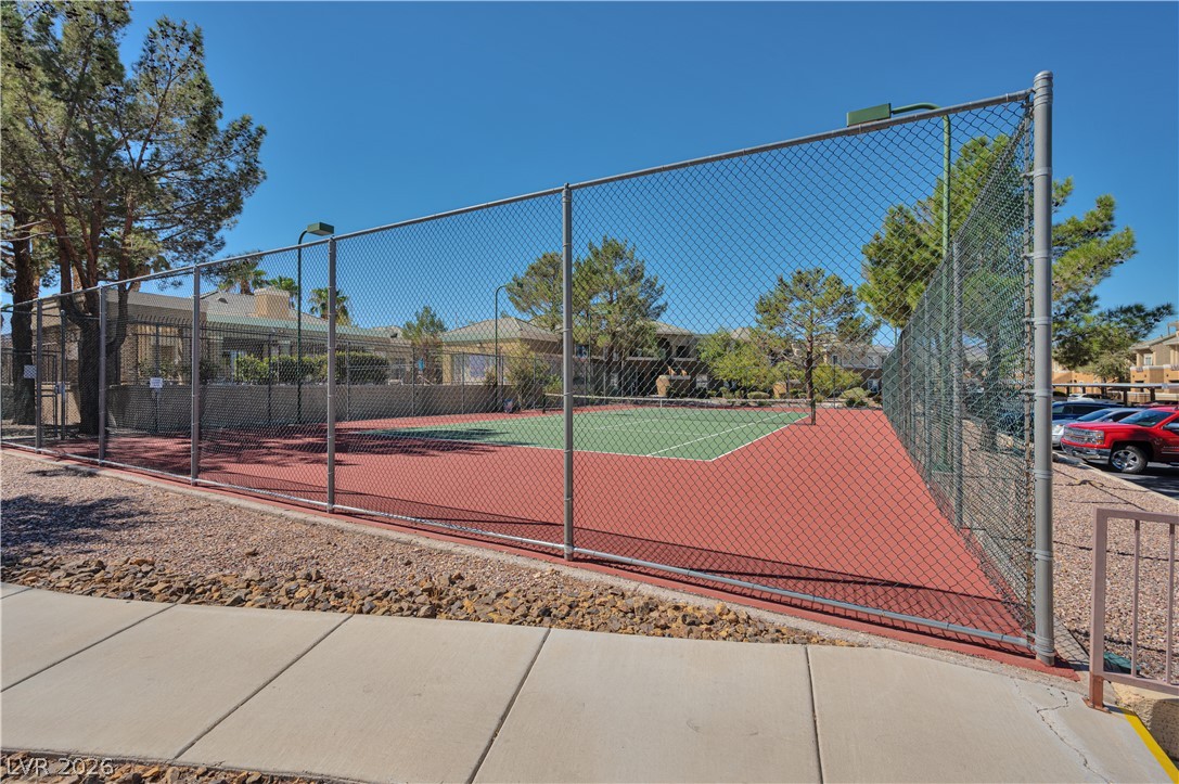 8025 West Russell Road, Unit 1090 Las Vegas, NV 89113 - Photo 20 of 23 A well-maintained community tennis court is fully enclosed by chain-link fencing.