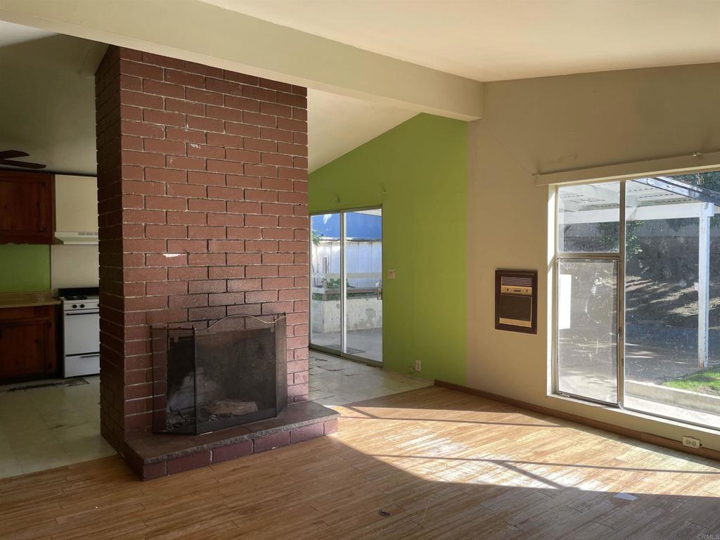 578 East Indian Rock Road Vista, CA 92084 - Photo 3 of 6 a view of empty room with wooden floor and fireplace