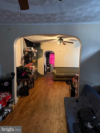 a living room with furniture and a gym machine