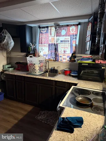 a kitchen with sink and view of living room