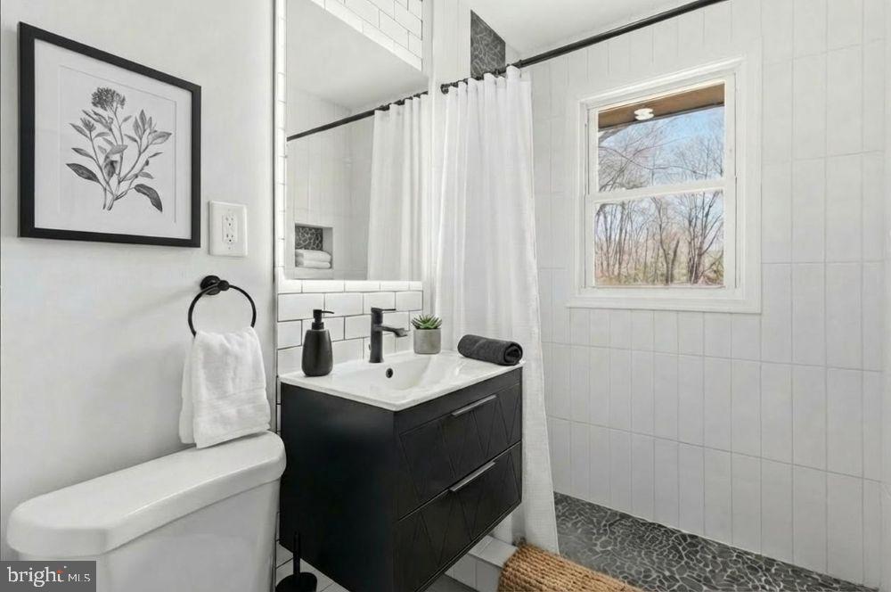 15924 Dusty Lane Accokeek, MD 20607 - Photo 10 of 22 a bathroom with a toilet sink and mirror