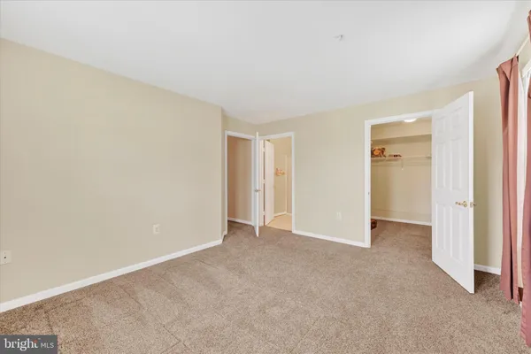 a view of an empty room and closet area