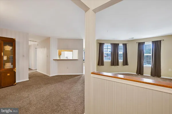 a view of a living room with furniture and window