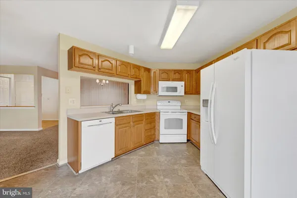 a kitchen with stainless steel appliances a refrigerator sink and stove