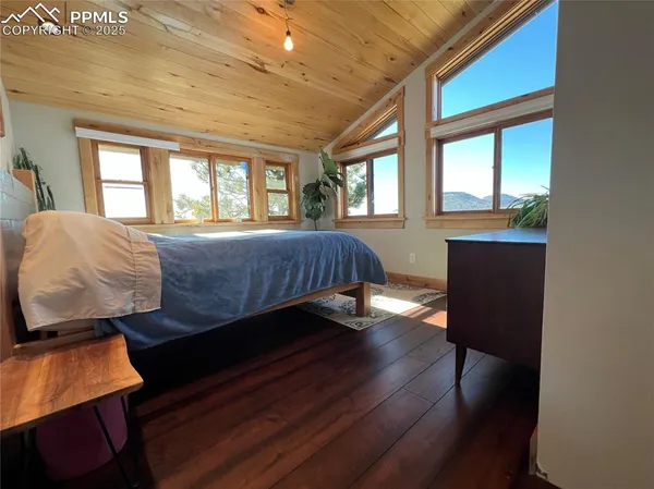 a bed sitting in a bedroom next to a window