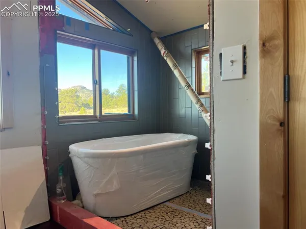 a white bath tub sitting in a bathroom