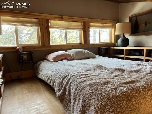 a bedroom with a large bed and a large window