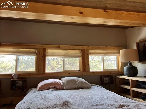 a bedroom with a bed and window