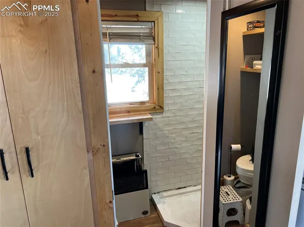 a bathroom with a toilet and a shower