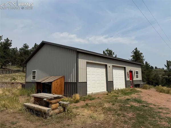 a backyard of a house with fire pit and barbeque oven